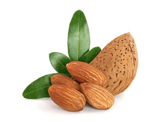 Group of almond nuts with leaves isolated on white background