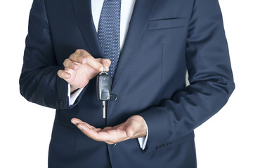 Hand with a car key. Isolated on white background