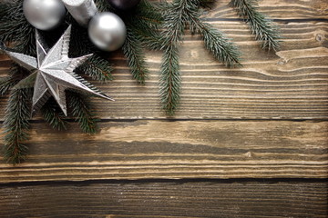 Christmas background with fir tree and decoration on dark wooden table 