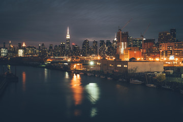 Fototapeta na wymiar night landscape of New York Manhattan reflected in water industrial landscape