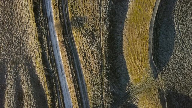 Aerial view over an ancient Motte and Bailey relief on a frozen winter morning at dawn in Oxfordshire England looking straight down