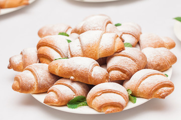croissants with sugar powder on the table