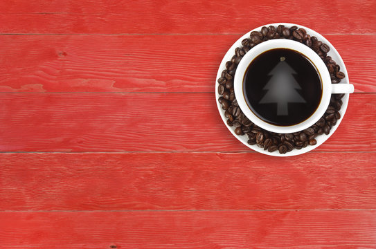 Top View Christmas Tree Reflective Light On Hot Black Coffee With Beans In White Cup On Vintage Red Wood Table With Copy Space For Christmas Party Or Happy New Year Background