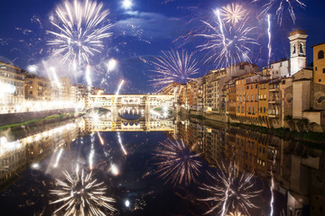 celebrating New year's eve in Florence, Italy - explosive fireworks around ponte vecchio on river...