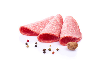 Salami smoked sausage slices isolated on white background with herbs