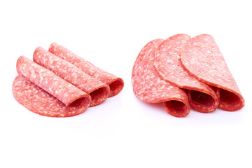 Salami smoked sausage slices isolated on white background with herbs