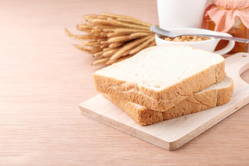 Fototapeta na wymiar slice of bread on wood background