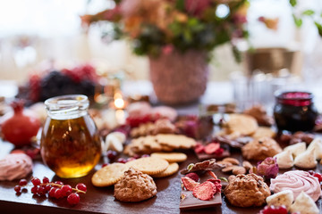 Delicious sweets on candy buffet. different sweets on a wooden table