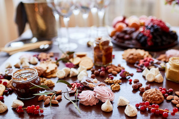 Delicious sweets on candy buffet. different sweets on a wooden table