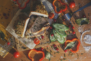 Baked meat on wooden frne with fresh vegetables and pepper/food