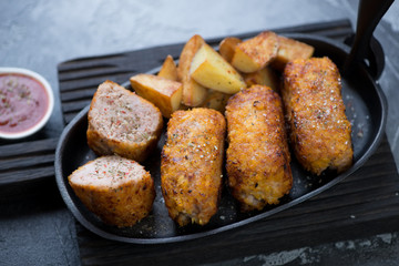 Close-up of turkey meat schnitzels served in a cast-iron frying pan, selective focus