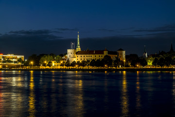 Fototapeta na wymiar View of the embankment of the river Daugava and the old town in Riga at sunset.