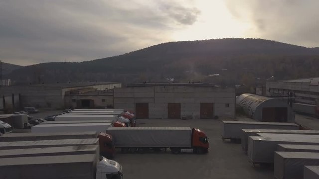 truck car with freight container driving out from warehouse area