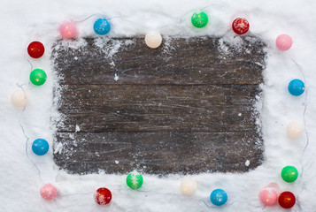 winter snowy frame on a wooden background