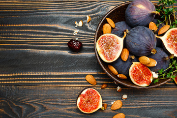 Figs and nuts on wooden background