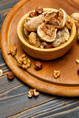 dried figs and nuts on wooden background