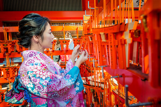 Women in traditional japanese kimonos at Fushimi Inari Shrine in Kyoto, Japan