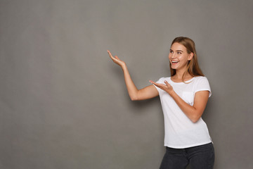 Excited woman shows something, point up