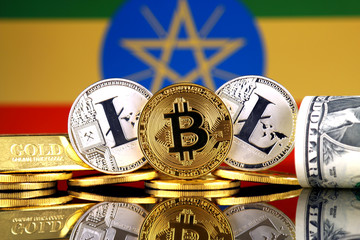Physical version of Bitcoin, Litecoin, gold, US Dollar and Ethiopia Flag. Conceptual image for...