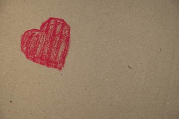 red heart drawn on a cardboard background