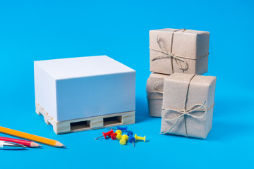 Obraz premium Small pallet and package boxes on blue background, Cargo freight ship, Logistic Import Export concept