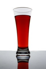 a glass of red wine on a dark white background 