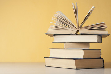 Open book, hardback books on wooden table. Education background. Back to school. Copy space for text.