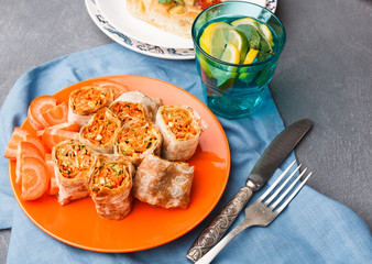 Rolls with vegetables on gray background.