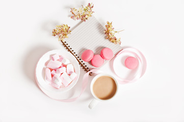 breakfast, morning coffee with marshmallows and macaroons, on white background. The concept of the beginning of the day.