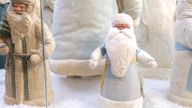 Soviet vintage santa claus figurines (ded moroz) on display in shopping mall. Panning, close up. 4K