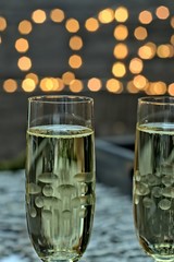 New year decoration concept-two glasses of champagne on a blurry gold background new year.