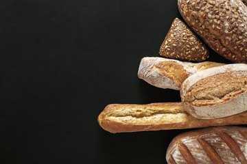 Bakery concept. Plenty of bread background isolated on balck