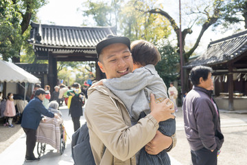A Japanese man holding a child