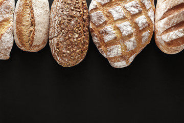 Bakery concept. Plenty of bread background isolated on balck