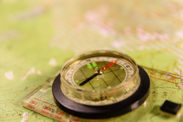 Magnetic compass lying on topographical map