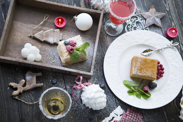 Christmas cakes and coctails decorated with holly and berries