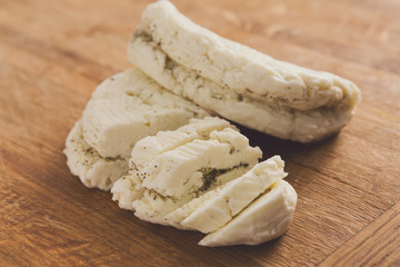 Homemade dairy, soft cheese, milk product on wood