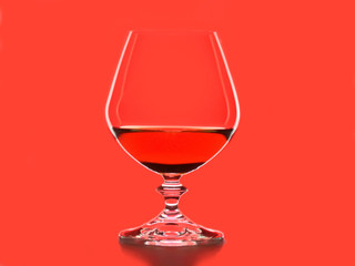 Silhouette of wineglass on red