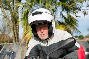 portrait of a senior biker on his motorcycle