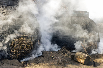 The production of charcoal in a traditional manner in the forest