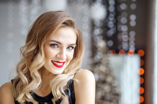 Portrait of a young woman with a red lipstick for Christmas. Concept of Happy Christmas and New Year, winter, party.