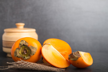 kaki fruit on a stone background