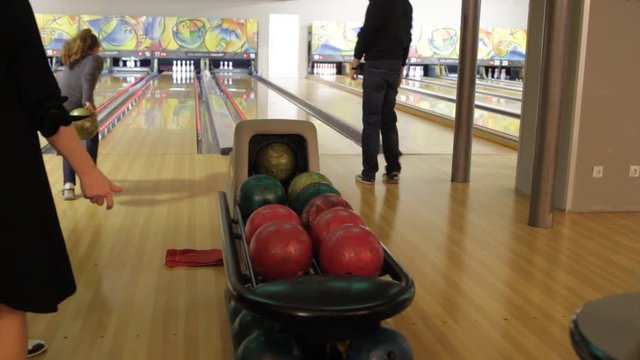 People playing a game of bowling at the small town bowling alley