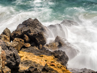 Waves hitting the rocks at Zuma Beach, long exposure, silk water - Zuma Beach, Los Angeles, LA, California, CA, USA