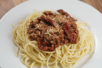 spaghetti bolognese on white plate closeup