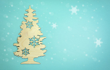 Obraz premium New Year background Christmas tree with snow flakes on light blue