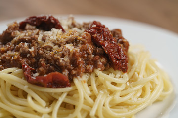 spaghetti bolognese on white plate closeup