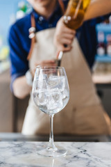 Wine glass with ice inside that ready for making cocktail.