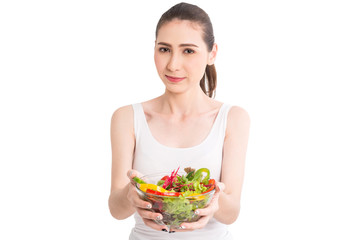 Woman holding fresh vegetable salad in glass bowl isolated on white background