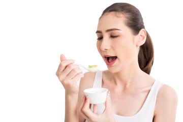 Young woman eating yogurt isolated on white background